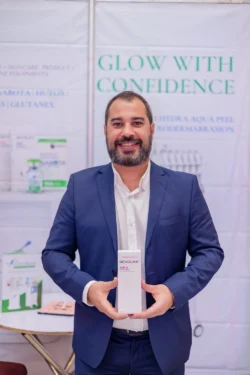 Man in a blue suit presents REVOLAX SUB-Q at a beauty booth. Man in blue suit presenting REVOLAX SUB-Q at beauty booth.